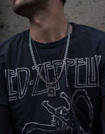 Load image into Gallery viewer, Made with love for whoever enjoys music.  Minimalist necklace featuring delicately designed vinyl player pendants and box chain. Elevate your style with our necklace, perfect for daily wear and layering. Crafted from high-quality stainless steel and available in silver color.  Material: Surgical steel, Color: Old silver. 60+5.5cm in length. | water-resistant, no-tarnishing, hypoallergenic |
