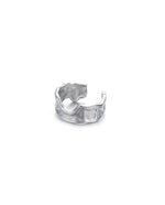 Load image into Gallery viewer, Open ring resembling the silhouette of waves.  Irregular texture of the surface inspired by the bold silhouette of a wave crashing. Elevate your style with our minimalist ring, perfect for daily wear and layering. Crafted from high-quality titanium and available in silver color.  Material: Titanium  | water-resistant, no-tarnishing, hypoallergenic |
